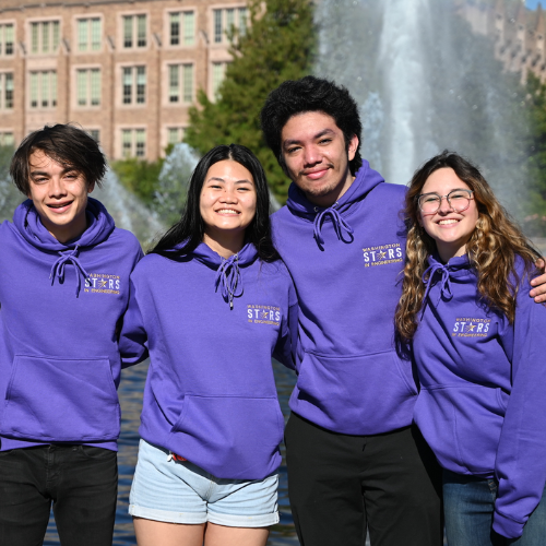 Group of students smiling in from of the UW fountain wearing STARS sweatshirts